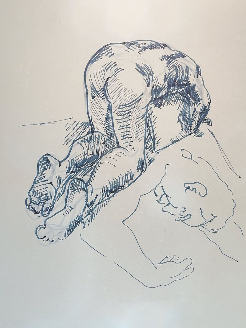 A male figure bends over a box in a loose fountain pen study.