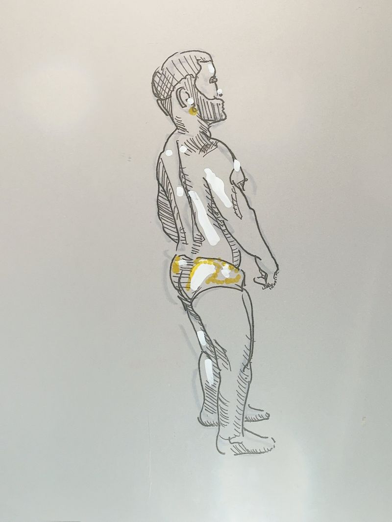 Luis standing, viewed from behind, in underwear.
